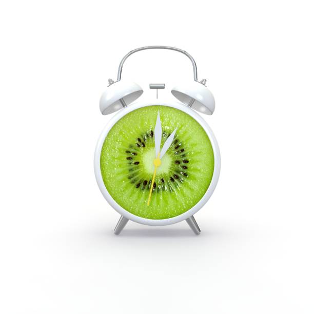 istock Kiwi slice alarm clock on white background. Minimal business concept 1173427667