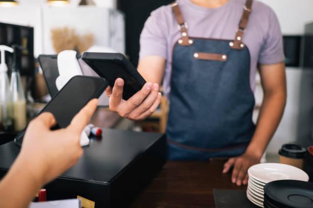 istock Customer doing contactless payment with phone in cafe. 1173427924