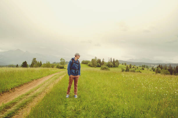 Traveler Man with backpack mountaineering Travel Lifestyle concept rocky mountains on background adventure vacations outdoor