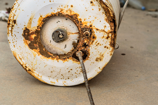 closeup of a rusty and leaking water heater