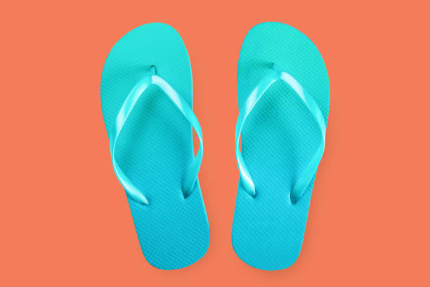 istock Green flip flops isolated on red background. Top view. Flat lay 1173437307