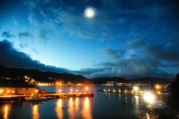 Simon's town port at twilight with full moon and illuminated piers