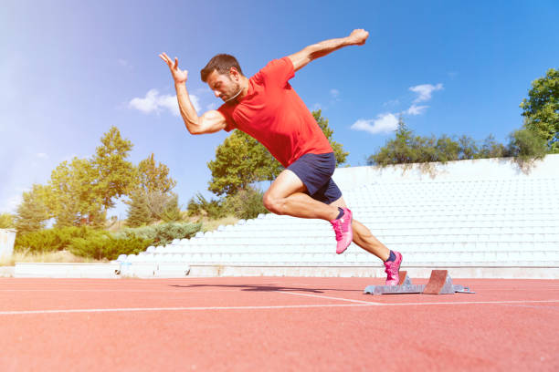 istock Runner using starting block to start his run on race track. 1173443835
