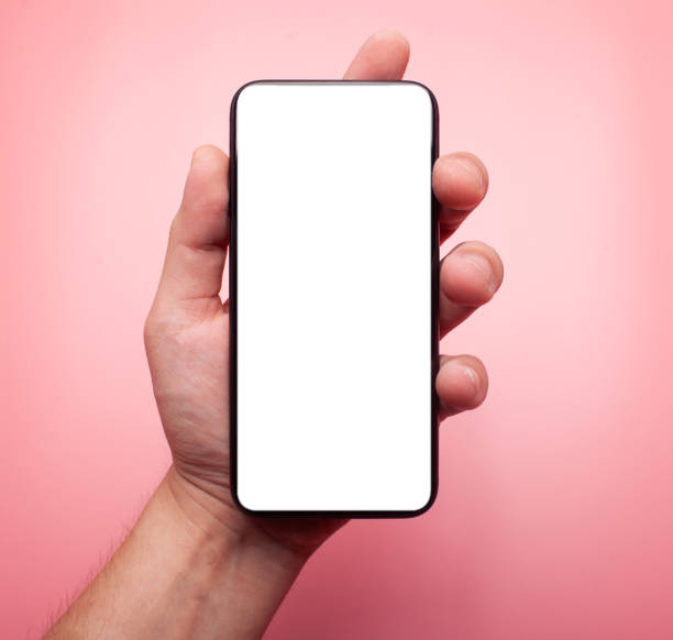 istock hand holds contemporary phone with blank screen isolated on pink background 1173446792