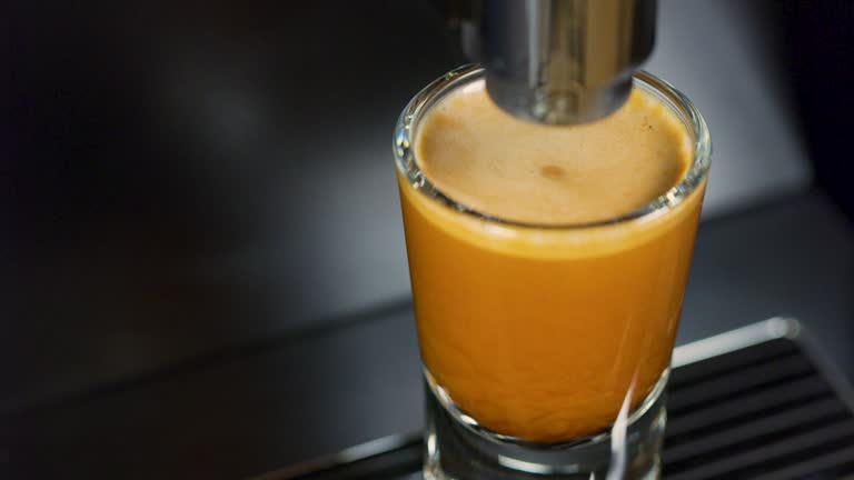 Close-up of strong espresso making at exclusive coffee machine