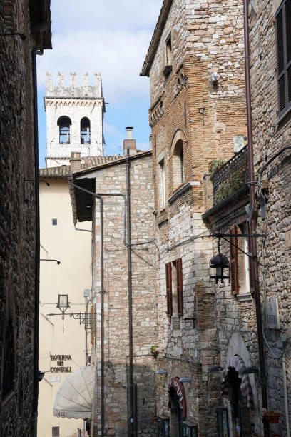 istock brick buildings and peoples tower in Assisi 1173451285