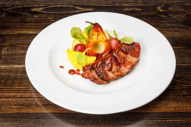 istock Grilled pork steak with caramel pear 1173457495