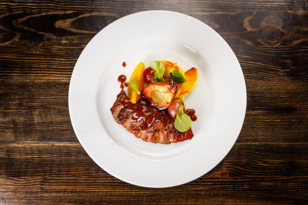 istock Grilled pork steak with caramel pear 1173457498