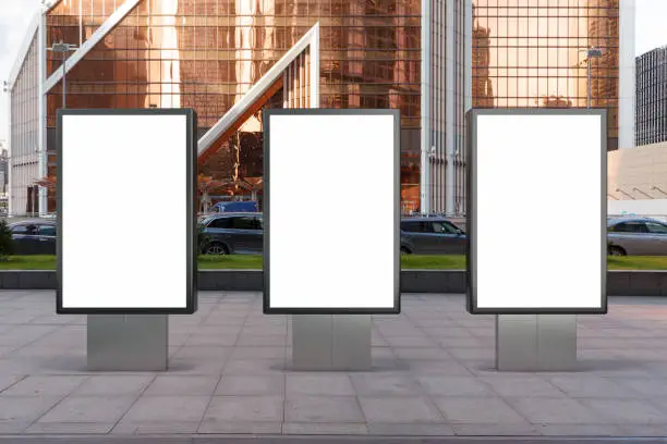 Three blank street billboard poster stands mock up in city downtown. 3d illustration.