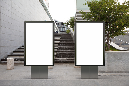 Two blank street billboard poster stands mock up in downtown. 3d illustration.