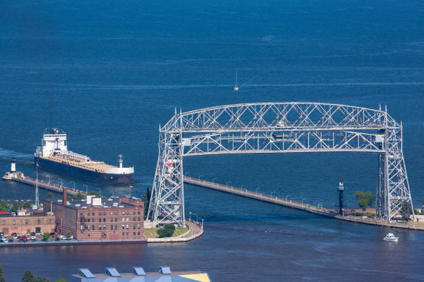 A Lift Bridge and A Ship A ship coming into harbor from Lake Superior. cantilever bridge stock pictures, royalty-free photos & images