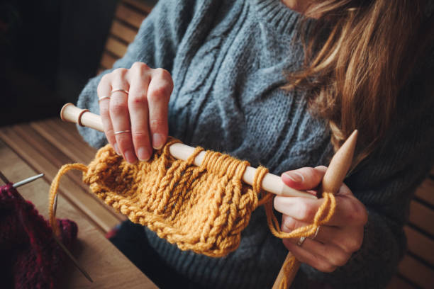 istock Close up on woman's hands knitting 1173466354