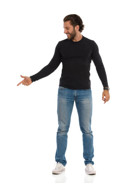 istock Handsome Man Is In Black Blouse And Jeans Is Looking Away And Pointing 1173466742