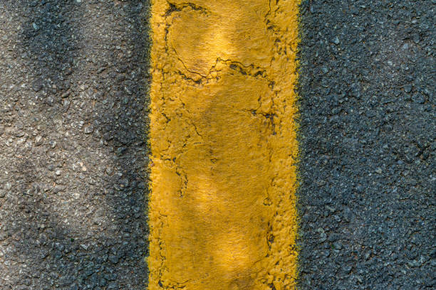 istock Asphalt texture with a yellow dividing strip. Top view 1173471525
