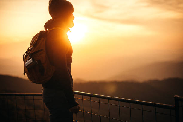istock Hiker watching sunrise on the top of mountain 1173476718