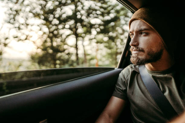 istock Handsome man with knit cap driving in car 1173476765
