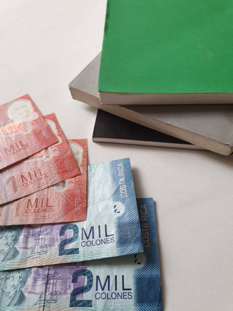 istock Costa Rican banknotes and stacked books 1173478403