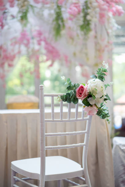 Wedding bouquet of the bride of white flowers roses on wooden background. Bride accessories. Close up. Side view.