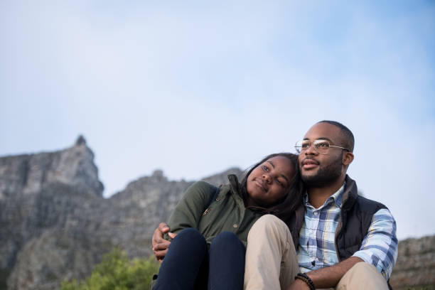 istock Affectionate couple looking at view against sky 1173480776