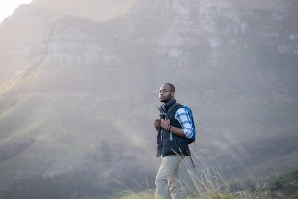 istock Portrait of hiker standing with backpack on cliff 1173484297