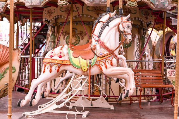 istock Retro-style carousel with horses. Rides in the park. 1173485049