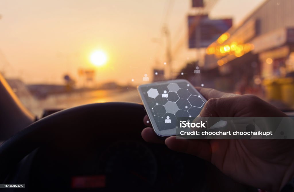 Close up of a man using mobile smart phone with map icon in car at sunset ,Business connection network concept,copy space. Map Stock Photo