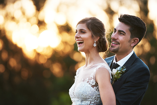 Shot of a happy young couple embracing outside on their wedding day