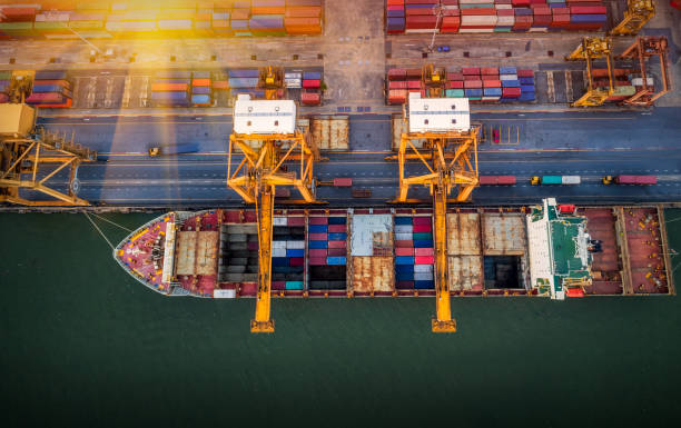 istock Logistics and transportation of Container Cargo ship and Cargo plane with working crane bridge in shipyard at sunrise, logistic import export and transport industry background 1173489371