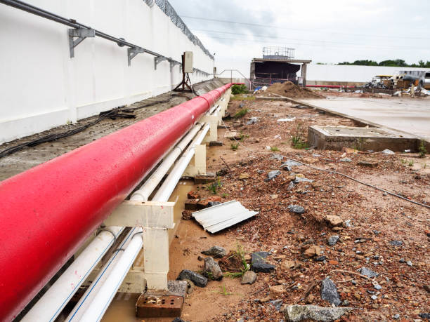 istock installed outdoor black steel pipe painted in red for fire production system 1173496254