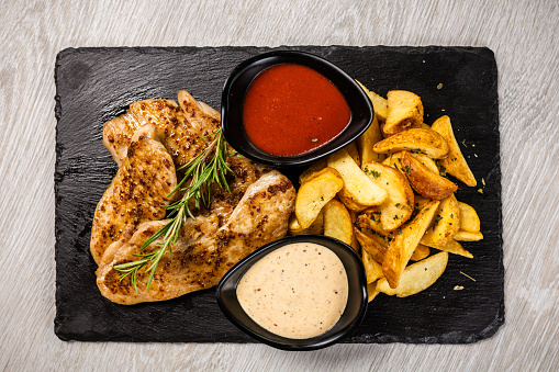 Grilled spicy chicken breast with rosemary and roasted potato