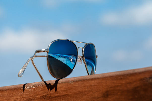 istock Sunglasses against a blue sky on the beach, summer accessories 1173500673