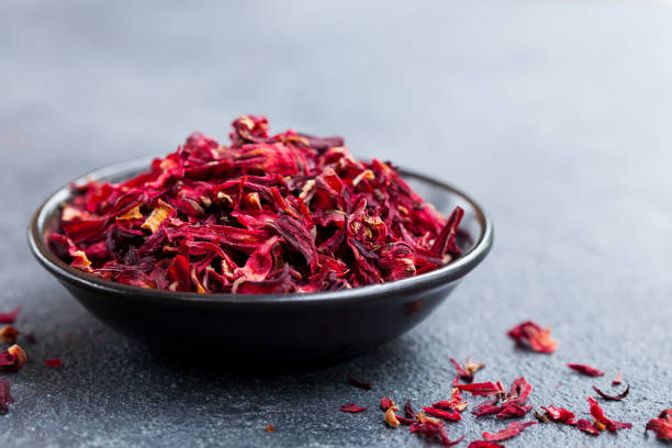 istock Hibiscus tea in black bowl. Grey slate background. Copy space. 1173500811