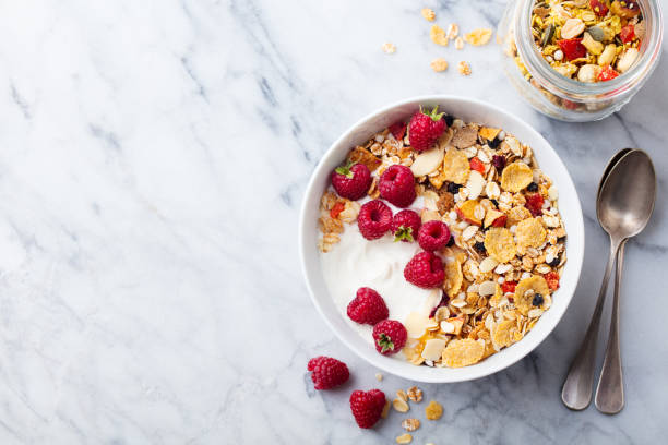 istock Healthy breakfast. Fresh granola, muesli, yogurt, berries on marble background. Top view. Copy space 1173502194