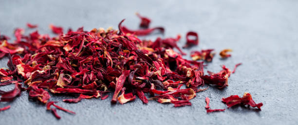 istock Hibiscus flower tea scattered on grey stone background. Copy space. 1173504058
