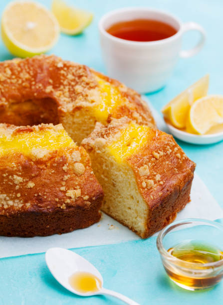 istock Lemon bundt cake with cup of tea. Blue background. Close up. 1173504451