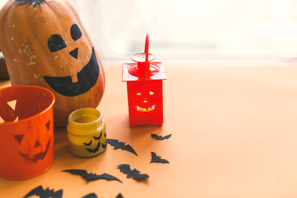 istock Halloween jack o lantern, pumpkin, candle, black bats and ghost paper decorations on yellow background.Trick or treat concept. Happy Halloween 1173504506