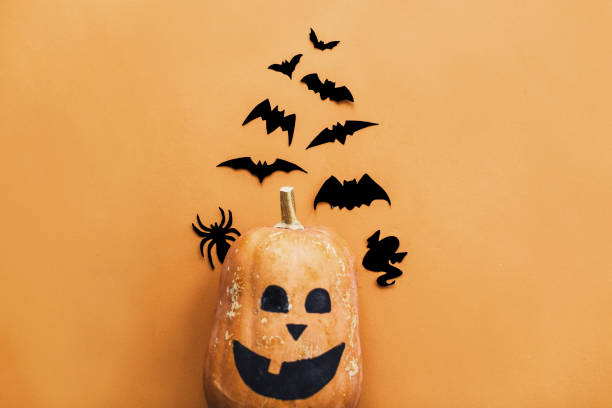 istock Pumpkin jack lantern and black bats, ghost, spider paper decorations on yellow background, copy space. Halloween flat lay. Trick or treat concept. Happy Halloween 1173505552