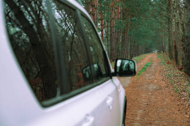 istock view of white suv car at forest trail 1173506763