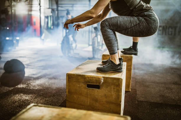istock Unrecognizable athlete jumping on crate during gym training in a gym. 1173507455