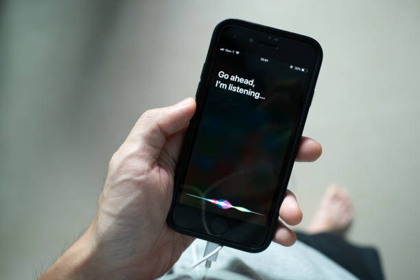 Siri, Apple's voice-activated digital assistant Bangkok, Thailand - July 30, 2019 : Siri, Apple's voice-activated digital assistant, tells iPhone user to ask her by showing the text "Go ahead, I'm listening" on the display. virtual assistant stock pictures, royalty-free photos & images