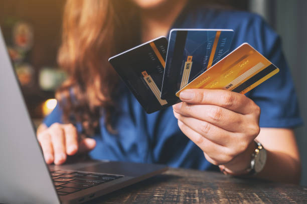 istock A woman holding credit cards while using laptop 1173510167