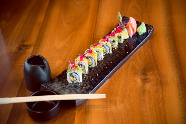 istock Sushi rolls on a black sushi plate 1173510254