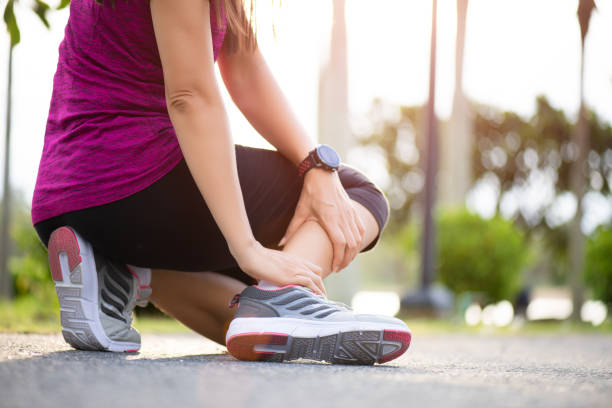 istock Ankle sprained. Young woman suffering from an ankle injury while exercising and running. Healthcare and sport concept. 1173511537