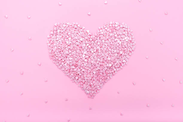 istock Pink background. Pink hearts on a pink background. Hearts sprinkles. 1173512583