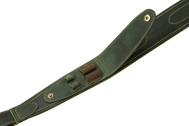 istock Green leather shoulder strap for a gun isolated on white background 1173513661