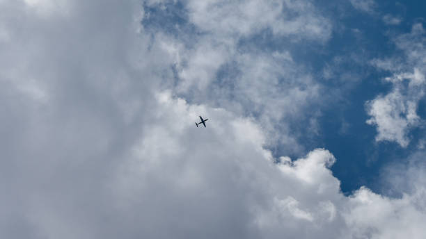 istock Airplane flying over the blue sky 1173513775