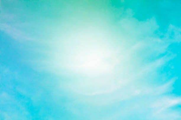 istock Abstract background of a vibrant clear blue teal sky with soft white clouds forming a frame for text 1173513934