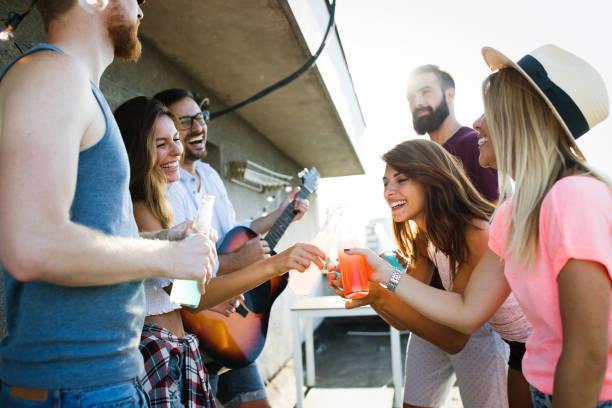 istock Group of happy friends having party on rooftop 1173515097