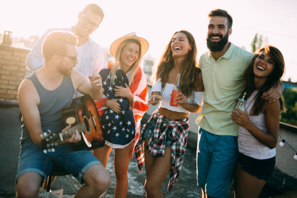 istock Group of happy friends having party on rooftop 1173515929