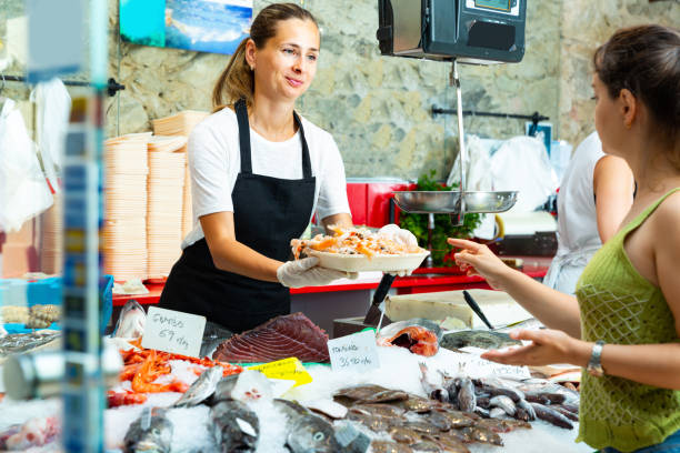 istock Nice woman demonstrating raw prawns 1173516252